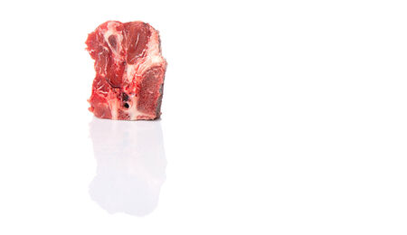 Chunk of cut frozen beef meat over white backgroundの写真素材