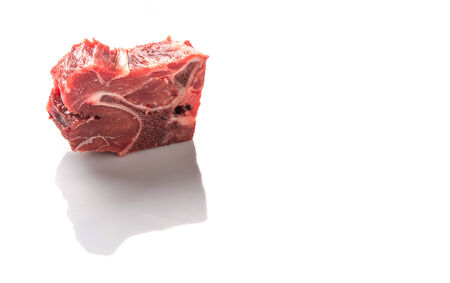Chunk of cut frozen beef meat over white backgroundの写真素材