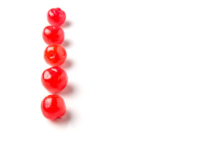 Pickled cherry fruit over white backgroundの写真素材