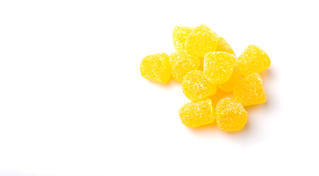 Yellow colored sugar jelly candy over white backgroundの写真素材