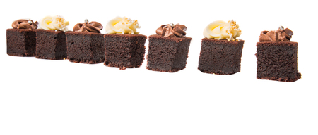 Bite sized chocolate cake with chocolate and cream cheese toppingsの写真素材