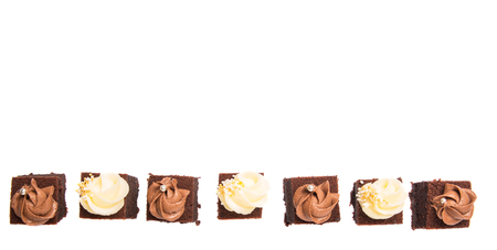 Bite sized chocolate cake with chocolate and cream cheese toppingsの写真素材