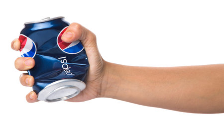 KUALA LUMPUR, MALAYSIA - JANUARY 12TH, 2015. Crushing a can of Pepsi . Pepsi is a carbonated soft...