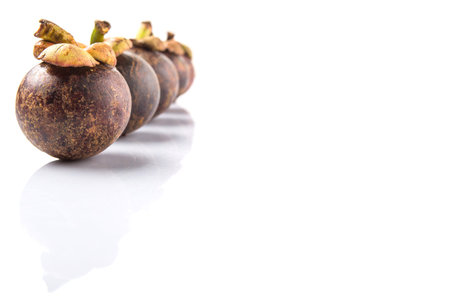 Ripe mangosteen fruit over white background