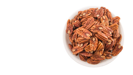 Pecan nut in a white bowl over white background