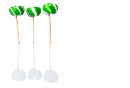 Green swirl peppermint candies over white backgroundの写真素材