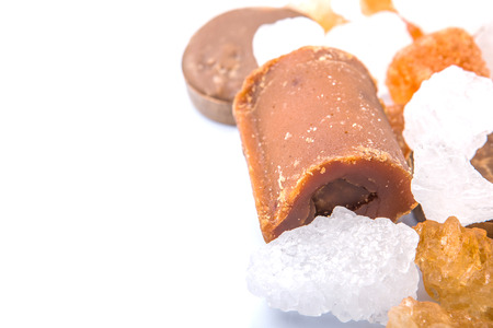 Palm sugar, coconut sugar, sugar cane rock and white rock sugar over white backgroundの写真素材