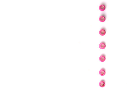 Pink colored wooden beads over white backgroundの写真素材
