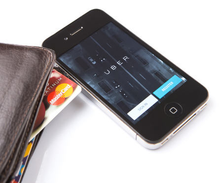 KUALA LUMPUR, MALAYSIA - FEBRUARY 8TH 2015. Credit card and Uber mobile apps. Uber is smartphone app-based transportation network and taxi company operating in 53 countries around the world.のeditorial素材
