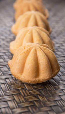 Kuih bahulu, a Malay sweet egg sponge cake on wicker mat.の写真素材