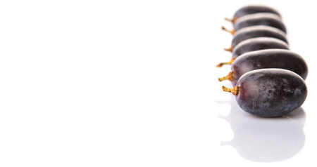 Black grapes over white backgroundの写真素材