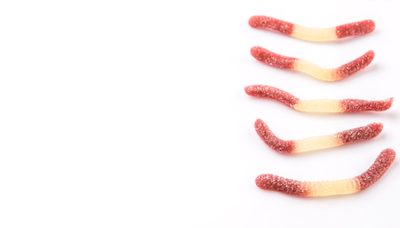 Brown and white sugar jelly candy strip over white backgroundの写真素材