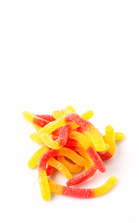 Red and yellow sugar jelly candy strip over white backgroundの写真素材