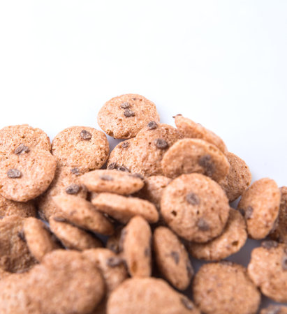 Chocolate flavored breakfast cereal over white background