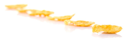 Corn flakes breakfast cereal over white background