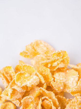 Corn flakes breakfast cereal over white background