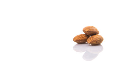 Raw almond nut over white backgroundの写真素材