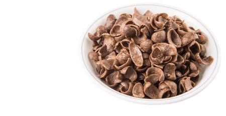 Crunchy chocolate breakfast cereal in white bowl over white background