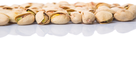 Pistachio nuts over white backgroundの写真素材