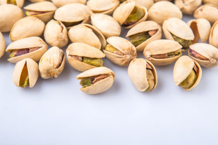 Pistachio nuts over white 