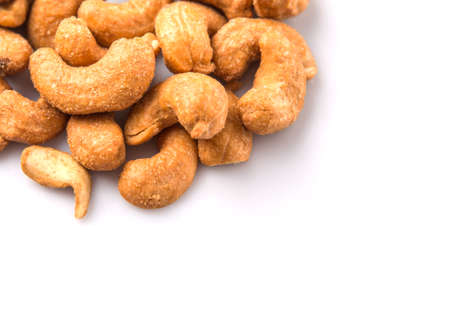 Roasted and salted cashew nut over white backgroundの写真素材