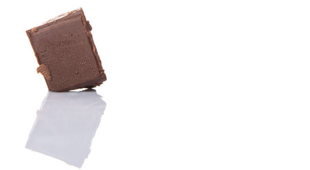 Dark brown chocolate pieces over white backgroundの写真素材