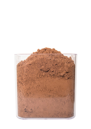 Cocoa powder in a plastic container over white backgroundの写真素材