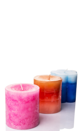 Pink, blue and brown colored aromatic candle over white backgroundの写真素材