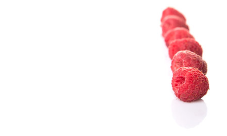 Raspberry fruit over white background