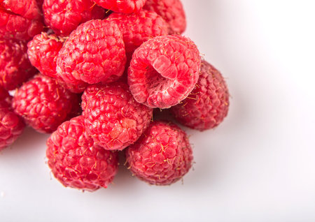 Raspberry fruit over white background