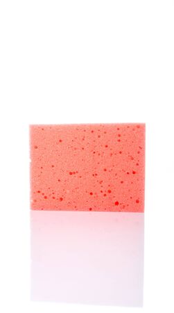 Red dish washing sponge over white backgroundの写真素材
