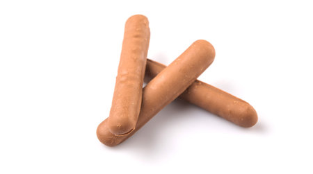 Chocolate coated finger biscuit over white backgroundの写真素材