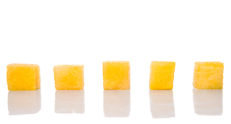 Bite size yellow watermelon over white backgroundの写真素材