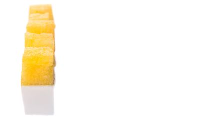 Bite size yellow watermelon over white backgroundの写真素材