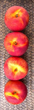 Nectarine fruit over wicker backgroundの写真素材