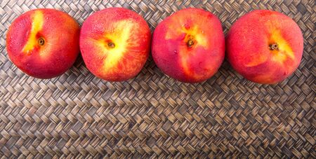 Nectarine fruit over wicker backgroundの写真素材
