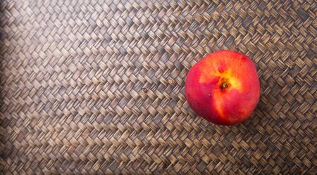 Nectarine fruit over wicker backgroundの写真素材