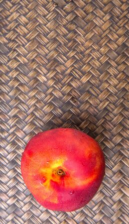 Nectarine fruit over wicker backgroundの写真素材