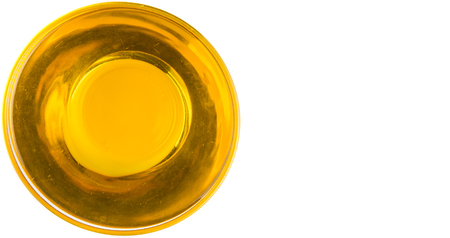 Vegetable cooking oil in a clear glass bowl over white backgroundの写真素材