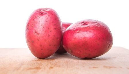 Red potatoes on wooden surfaceの写真素材