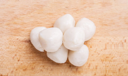 Raw white fish balls on a wooden surfaceの写真素材