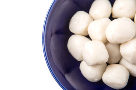 Fish balls in a blue bowl over white backgroundの写真素材
