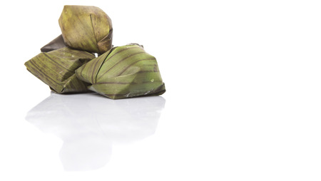 Traditional Malay dumpling Kuih Koci made from glutinous rice flour with coconut filling wrapped in banana leaves and steamed.の写真素材