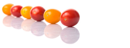 Yellow and red grape tomato over white backgroundの写真素材