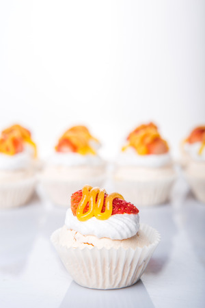 Mini pavlova with strawberry topping over white backgroundの写真素材