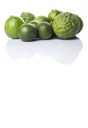 Lime makrut or kaffir lime and calamansi over white backgroundの写真素材