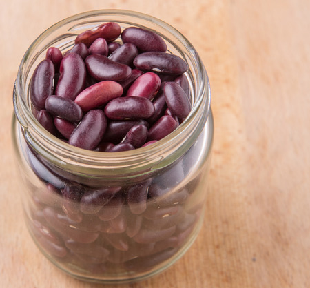 Red kidney beans in mason jar over wooden backgroundの写真素材