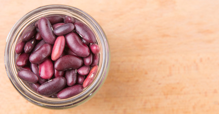 Red kidney beans in mason jar over wooden backgroundの写真素材
