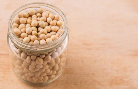 Soy bean in a mason jar on wooden surfaceの写真素材