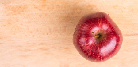 Red apple over wooden backgroundの写真素材